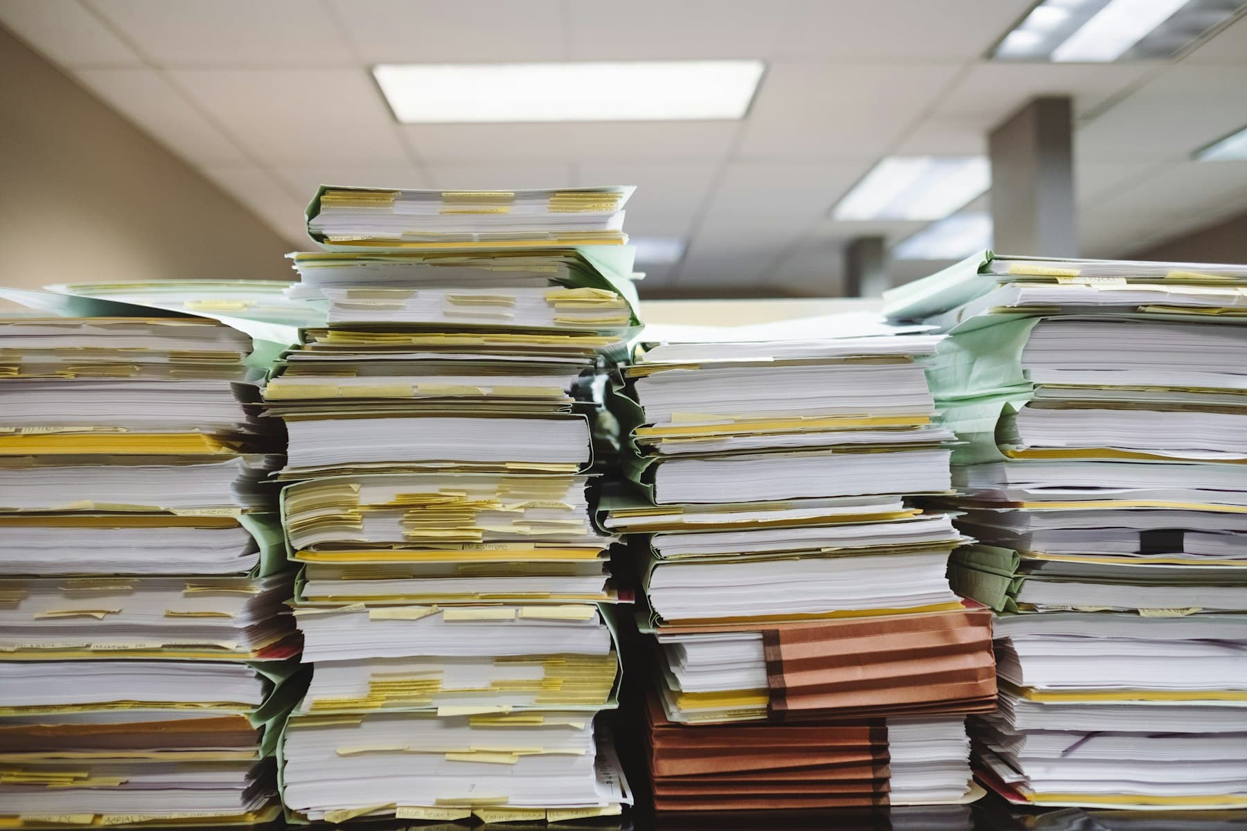 Stacks of paper files waiting to be keyed in