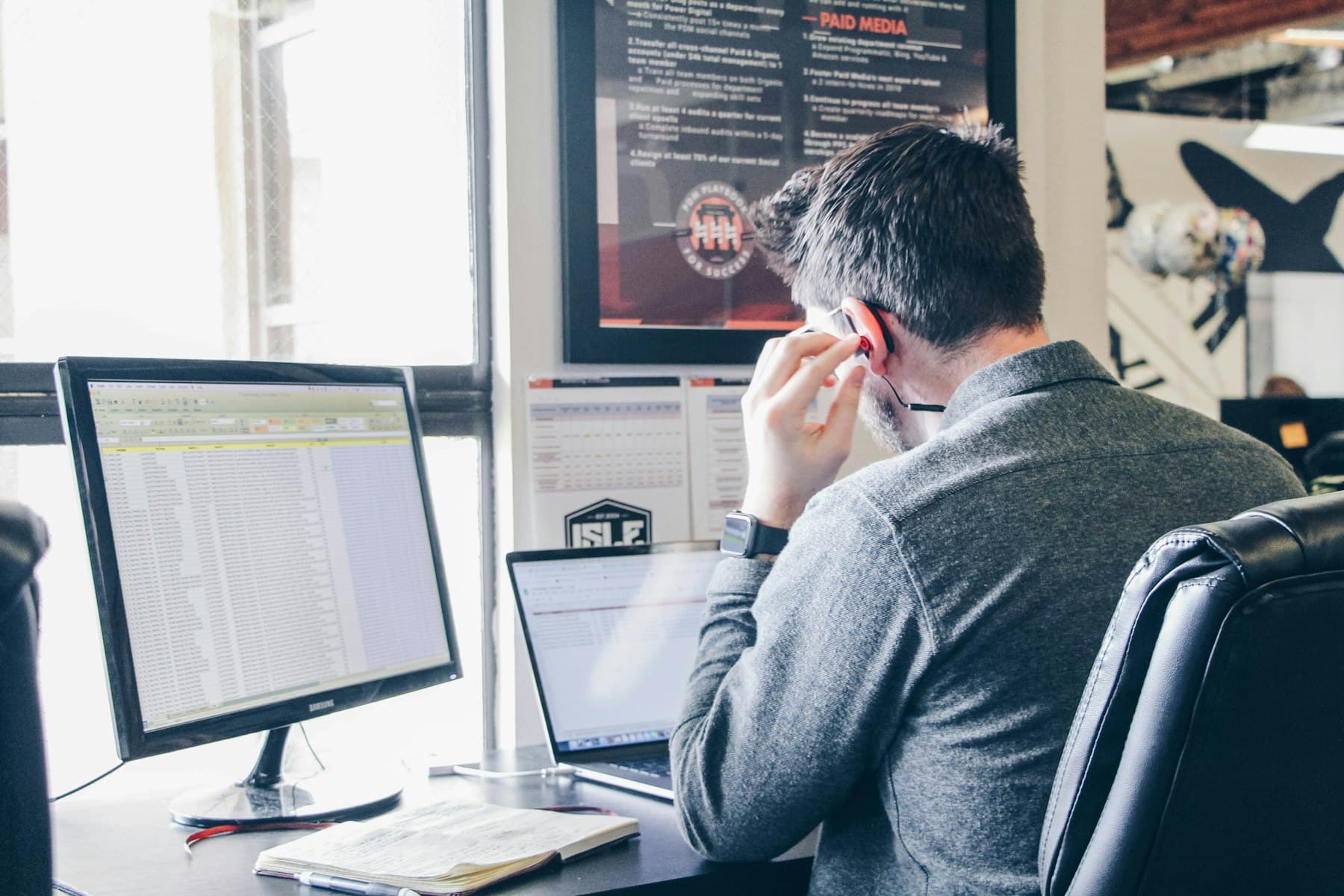 Operations analyst reviewing a spreadsheet at his desk